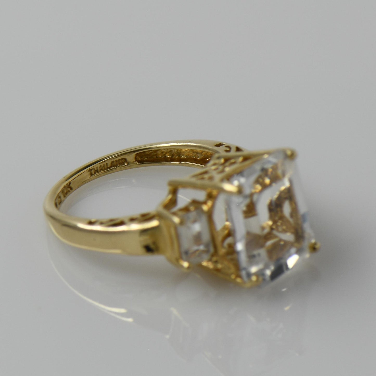 White Topaz Emerald Cut Three Stone 10k Yellow Gold Ring