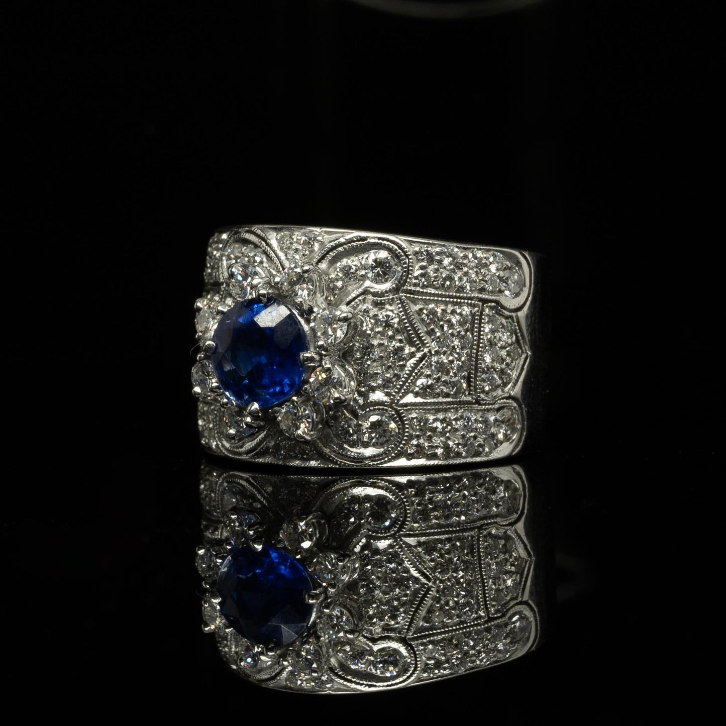 Vivid Blue Round Sapphire in Wide Diamond 18k White Gold Ring