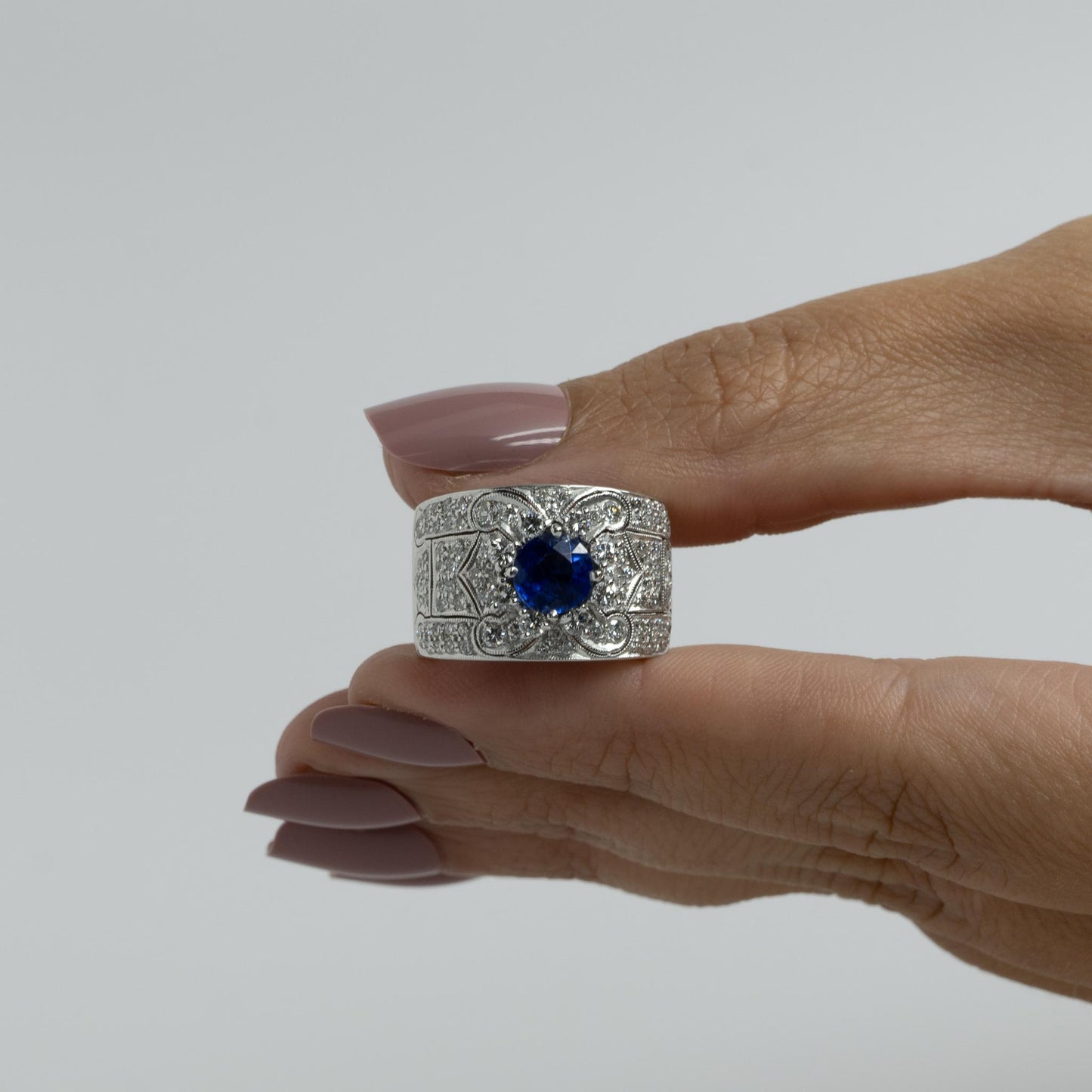 Vivid Blue Round Sapphire in Wide Diamond 18k White Gold Ring