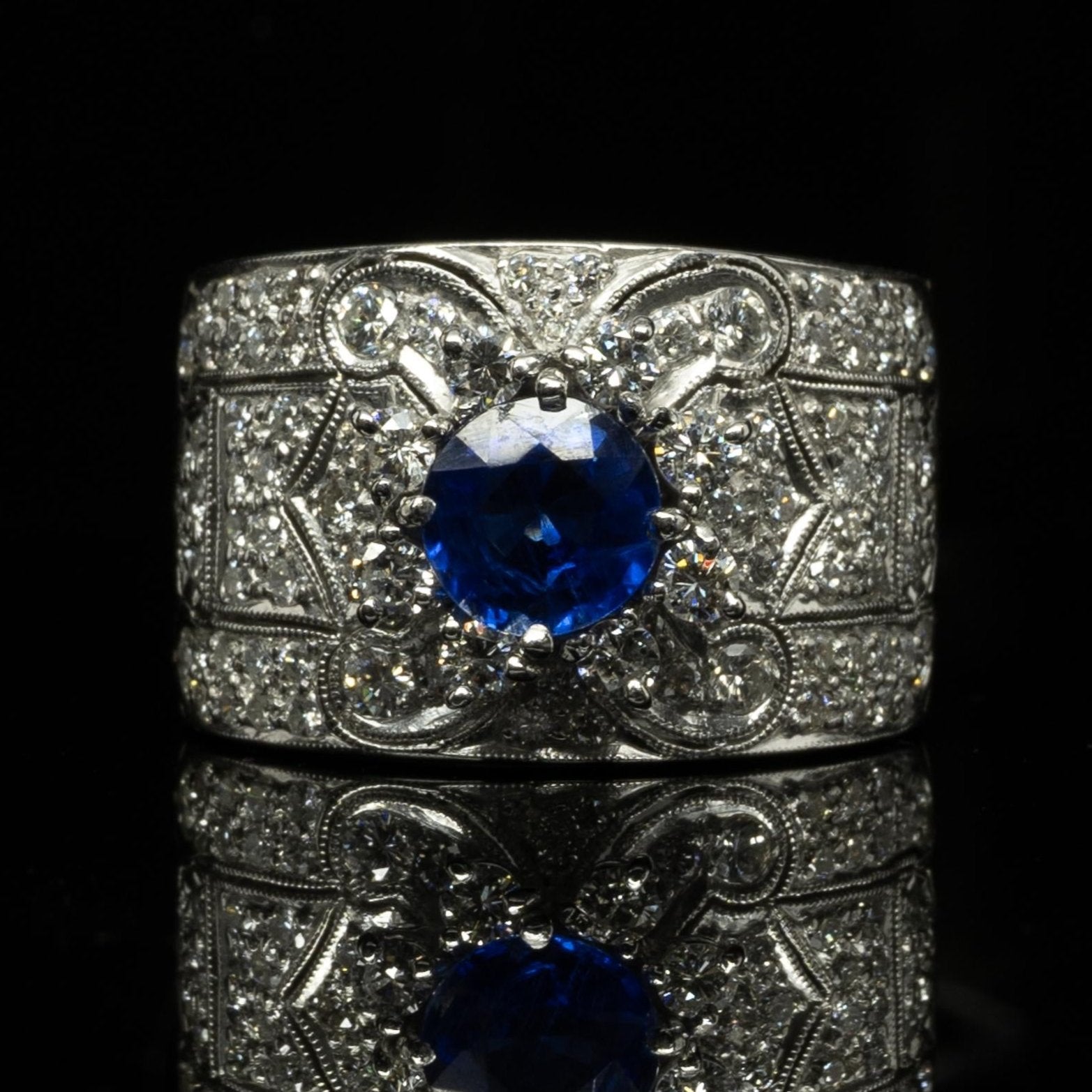 Vivid Blue Round Sapphire in Wide Diamond 18k White Gold Ring